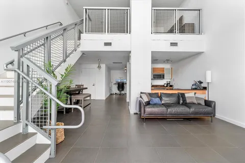a living room with furniture gym equipment and white walls