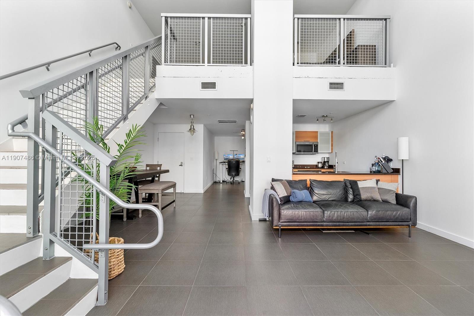 a living room with furniture gym equipment and white walls