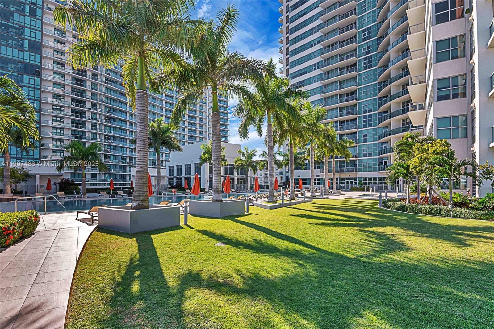 3301 Northeast 1st Avenue, Unit M0502 Miami, FL 33137 - Photo 28 of 29 a view of swimming pool with outdoor seating and a palm tree