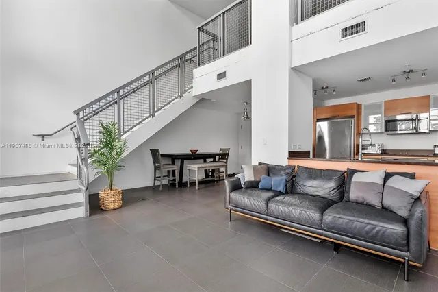 a living room with furniture and stairs