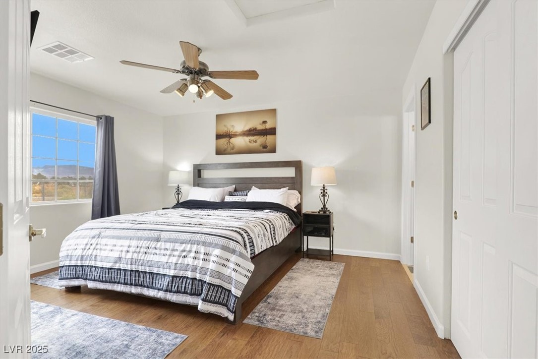 4391 Emma Street Pahrump, NV 89048 - Photo 15 of 28 Bedroom featuring wood finished floors, a ceiling fan, and a closet
