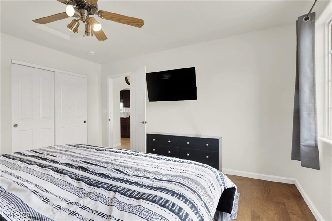4391 Emma Street Pahrump, NV 89048 - Photo 17 of 28 Bedroom featuring wood finished floors, a ceiling fan, and a closet