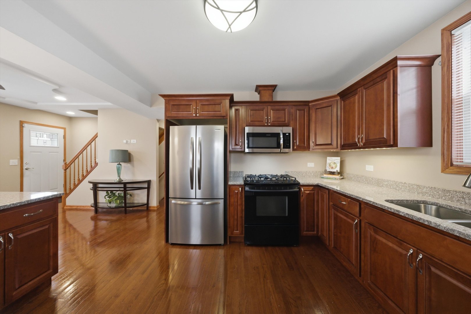 3719 211th Place Matteson, IL 60443 - Photo 11 of 48 a kitchen with granite countertop stainless steel appliances and wooden cabinets