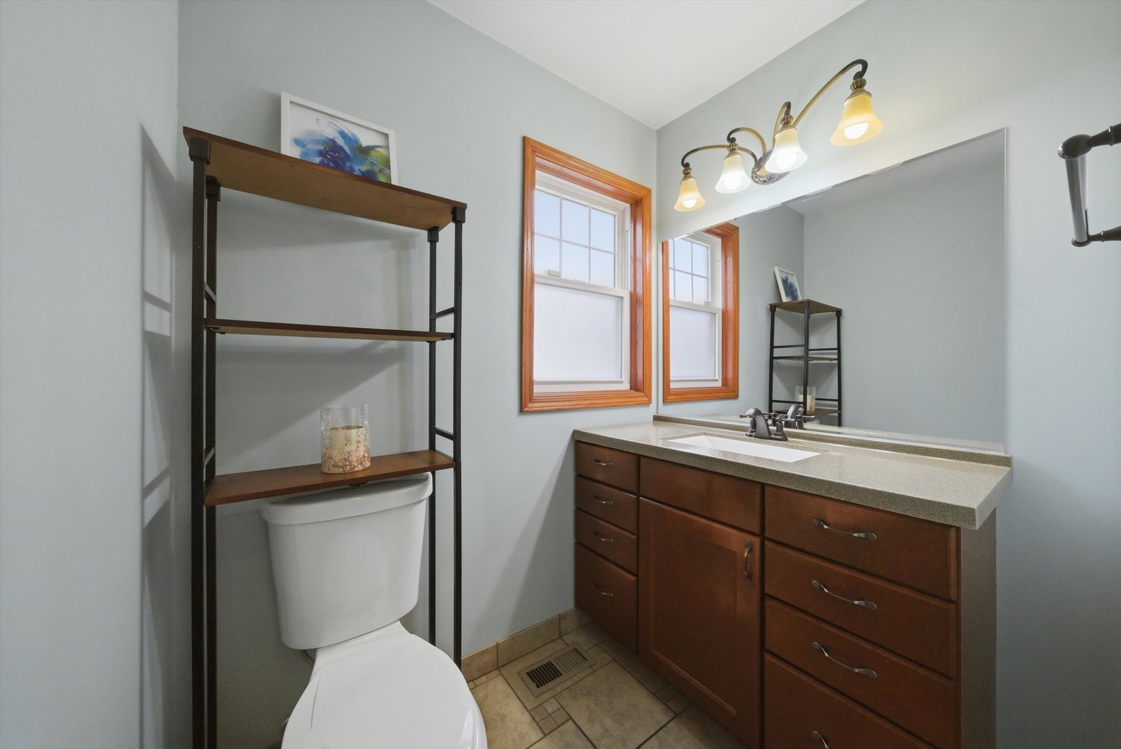 3719 211th Place Matteson, IL 60443 - Photo 15 of 48 a bathroom with a toilet a sink and mirror