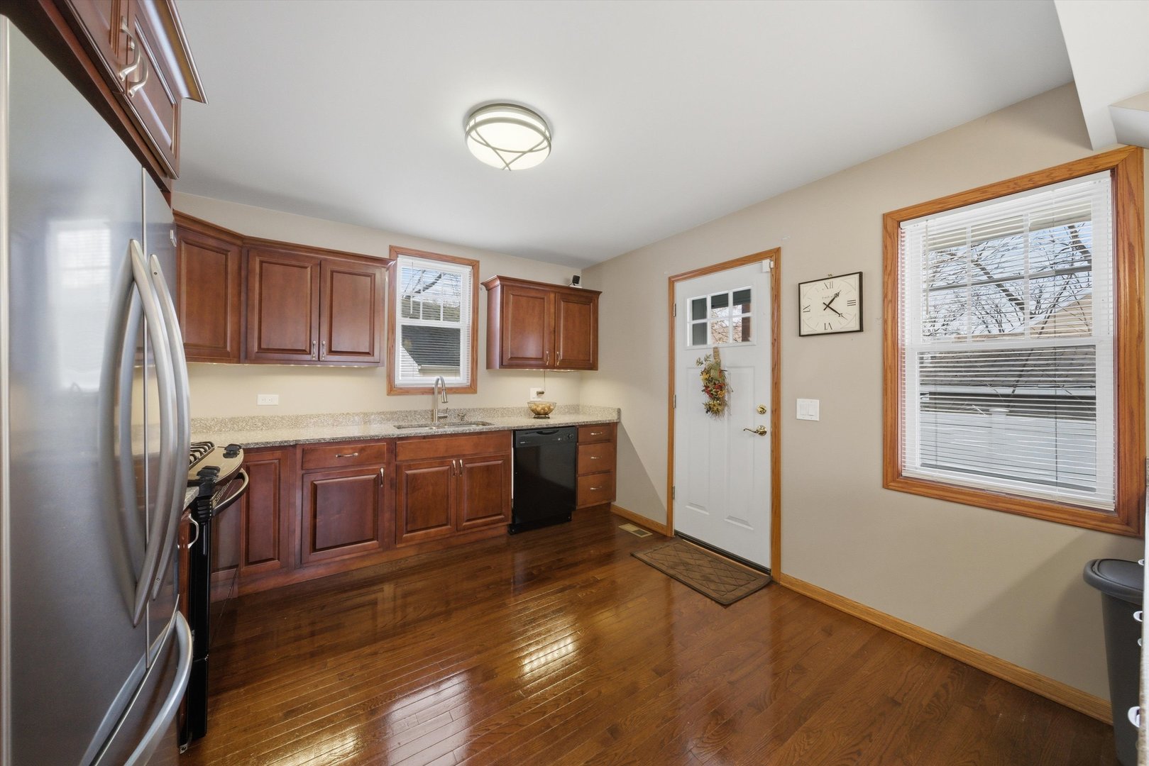 3719 211th Place Matteson, IL 60443 - Photo 8 of 48 a kitchen with stainless steel appliances granite countertop a refrigerator sink and wooden cabinets