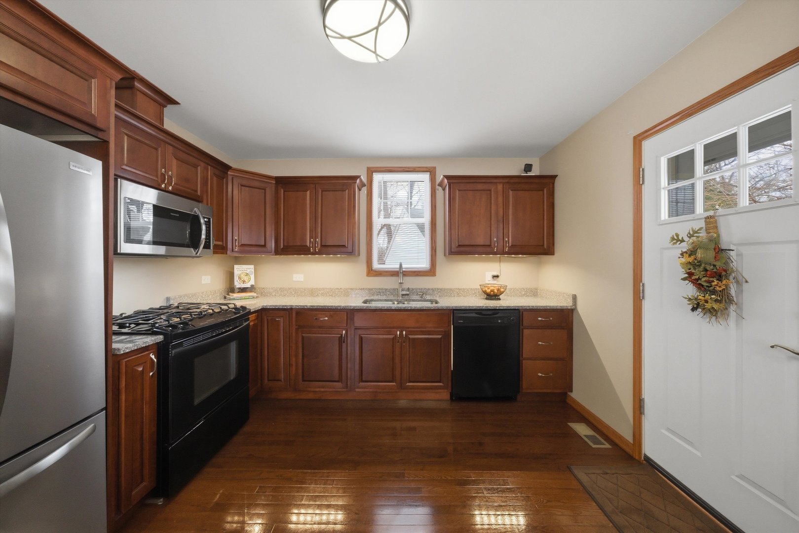 3719 211th Place Matteson, IL 60443 - Photo 9 of 48 a kitchen with stainless steel appliances granite countertop a stove sink and cabinets