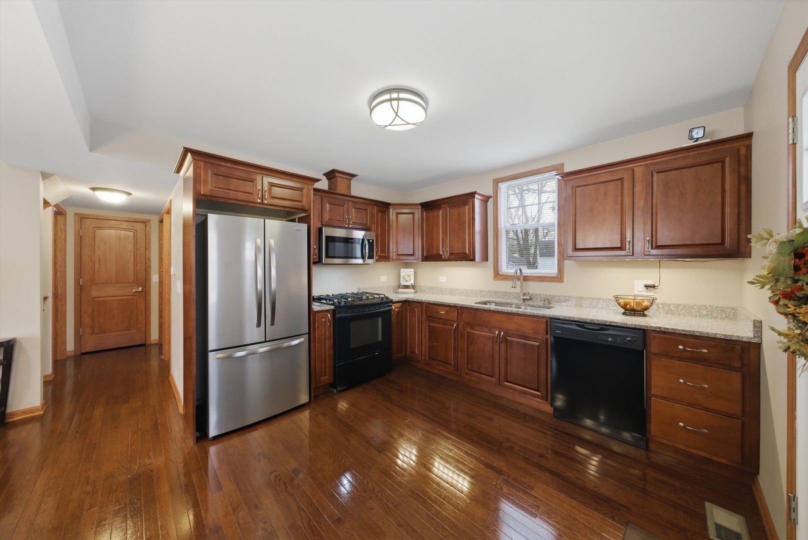 3719 211th Place Matteson, IL 60443 - Photo 10 of 48 a kitchen with granite countertop a refrigerator stove top oven and sink
