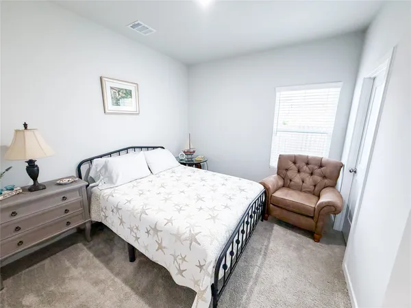 a bedroom with a bed and a couch