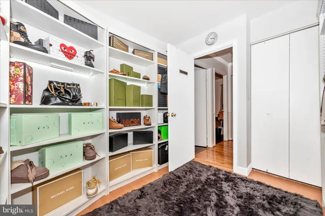 a view of a room with wooden floor and ceiling fan