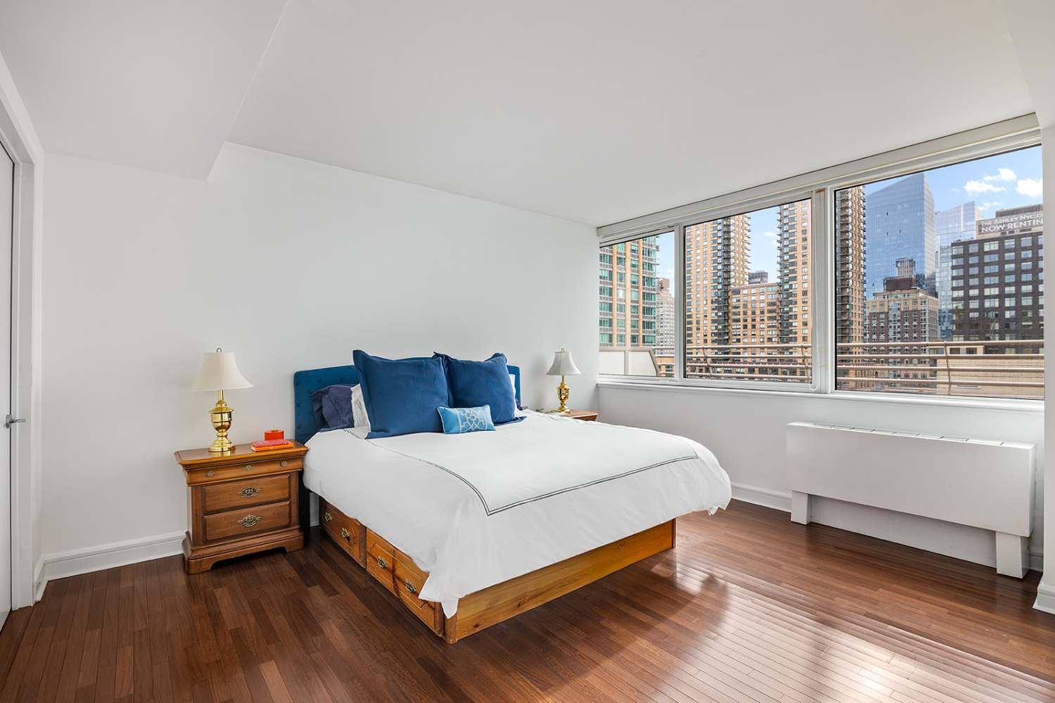 120 Riverside Boulevard, Unit 16K Manhattan, NY 10069 - Photo 5 of 7 a bedroom with a bed and a large window