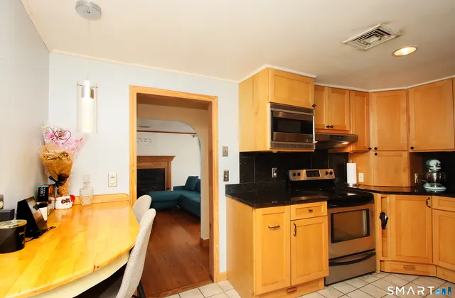 a kitchen with a sink appliances and cabinets
