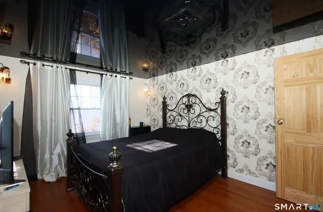 a bed sitting in a bathroom next to a window