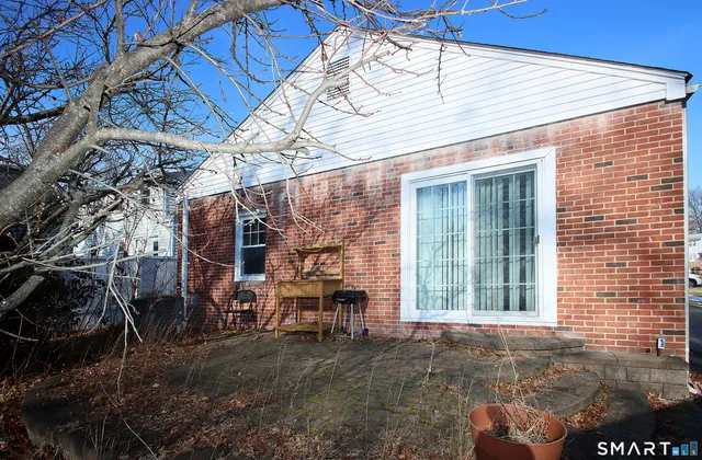 a view of a two chairs in the backyard