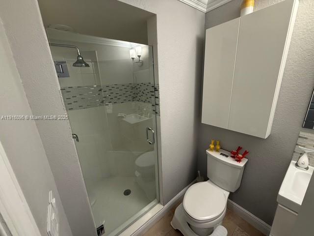 16420 Southwest 48th Terrace Miami, FL 33185 - Photo 20 of 58 a white toilet sitting next to a bathroom sink and a shower