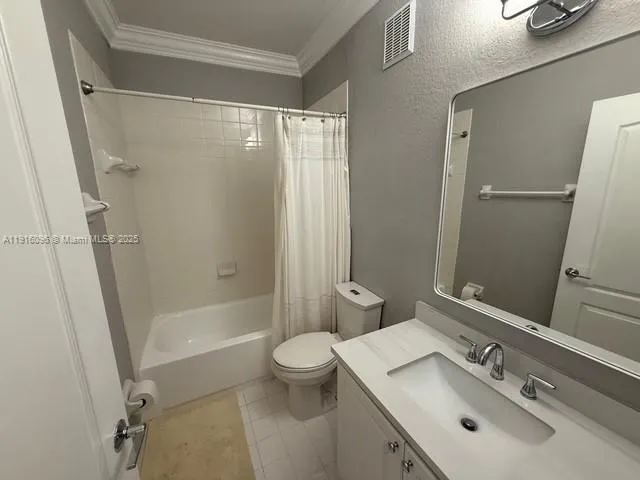 a view of a bedroom with wooden floor and chandelier