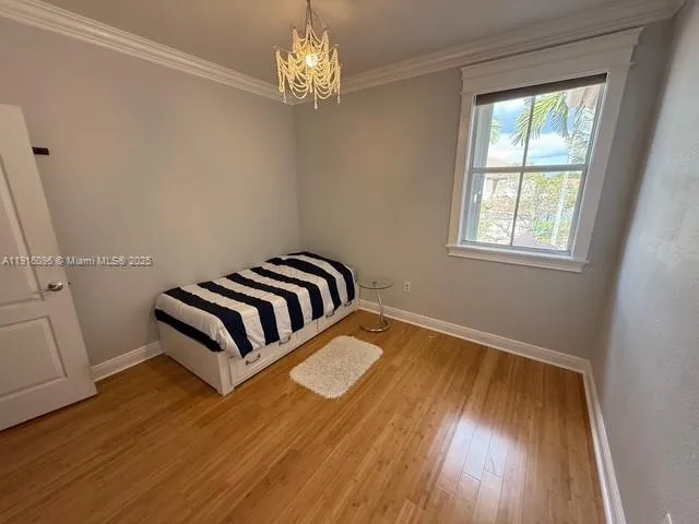 a bedroom with a bed and lamp with window