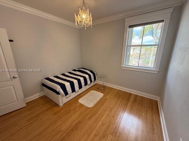 16420 Southwest 48th Terrace Miami, FL 33185 - Photo 36 of 59 a view of a bedroom with wooden floor and chandelier