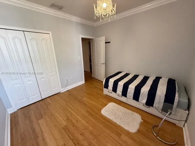 a bedroom with a bed and a lamp