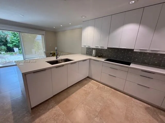 a kitchen with a refrigerator and a sink