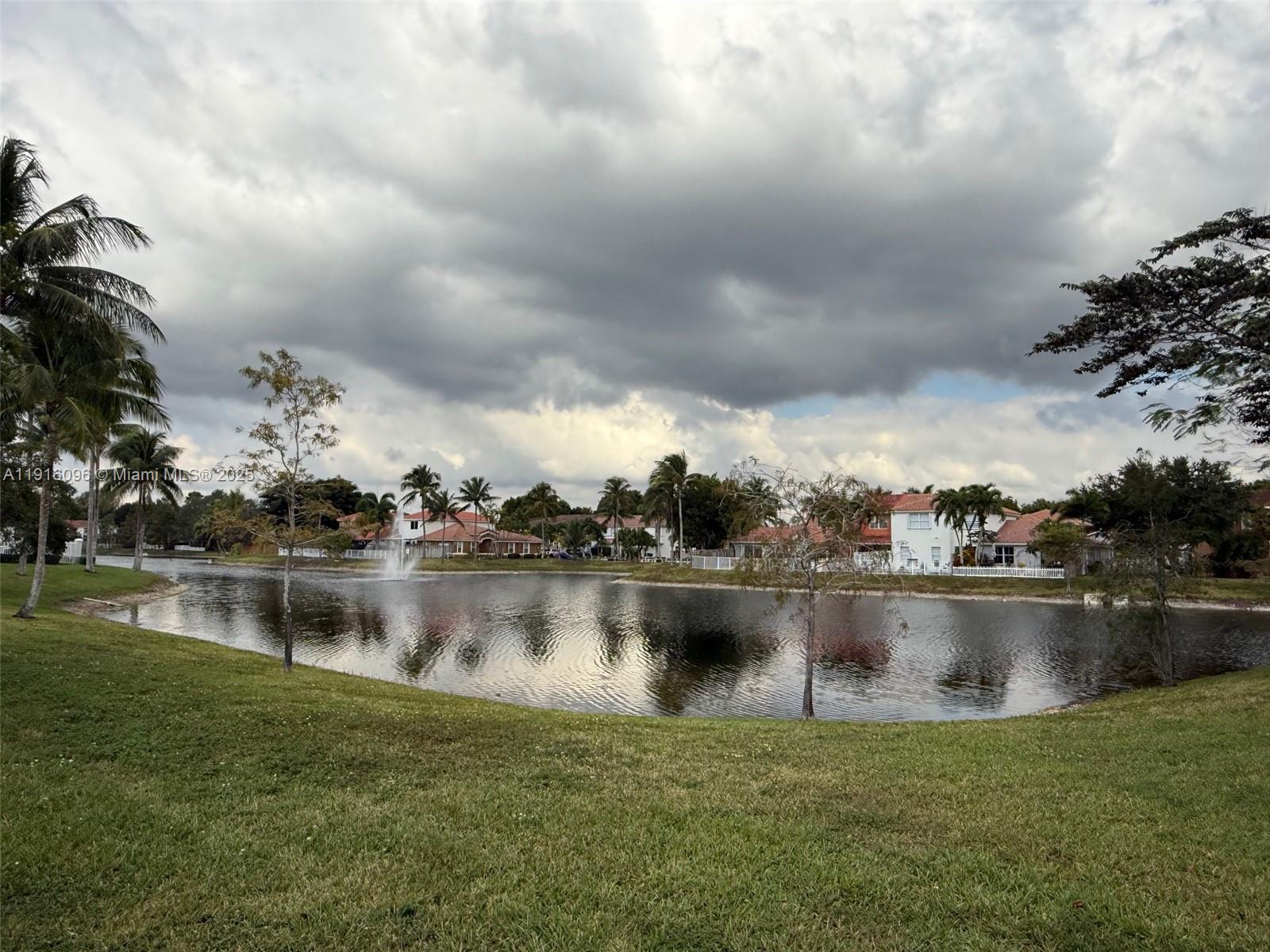 16420 Southwest 48th Terrace Miami, FL 33185 - Photo 55 of 58 a view of a lake with houses in the back