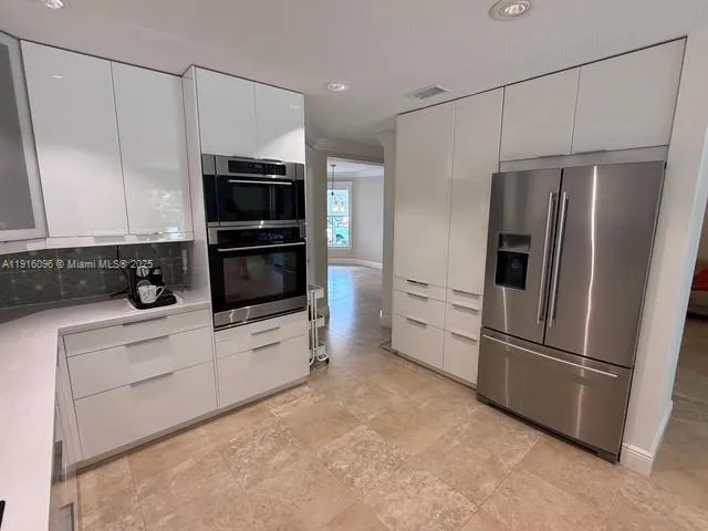 a kitchen with stainless steel appliances a sink and a stove