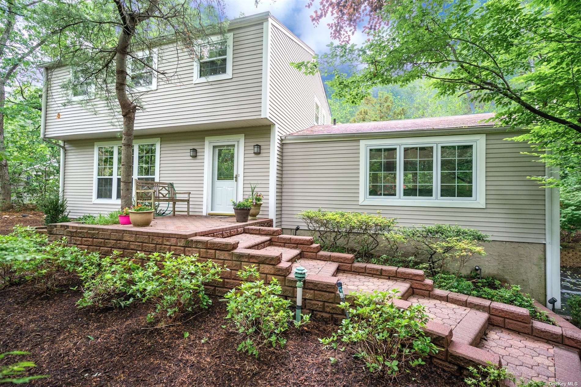 131 Oakwood Road Port Jefferson, NY 11777 - Photo 1 of 1 a front view of a house with garden