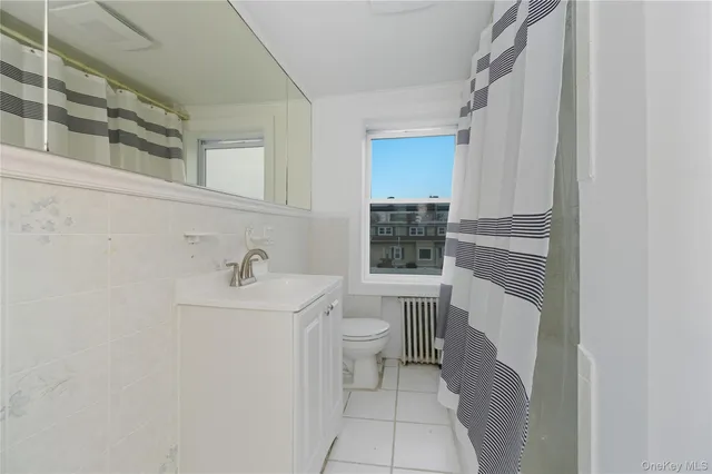 a bathroom with a sink a toilet and window