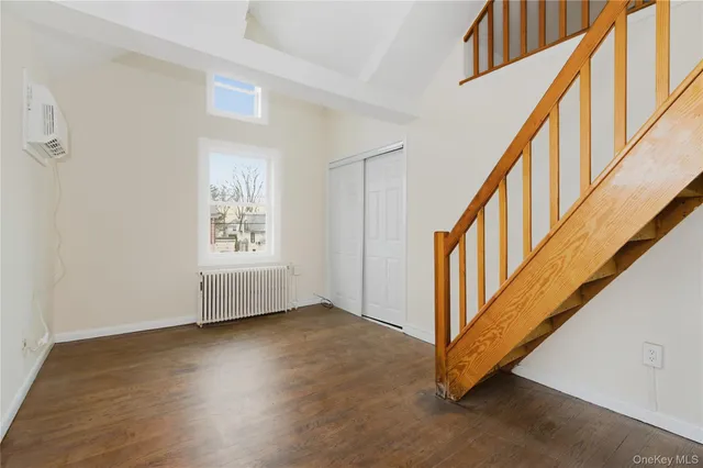 a view of an entryway with wooden floor