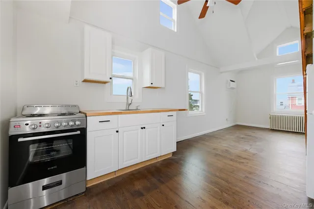 a view of a kitchen with a stove top oven