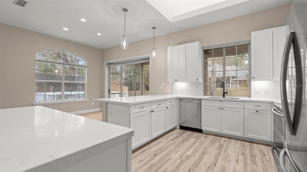 9428 Southwest 39 Avenue Gainesville, FL 32608 - Photo 11 of 43 a large white kitchen with a large window