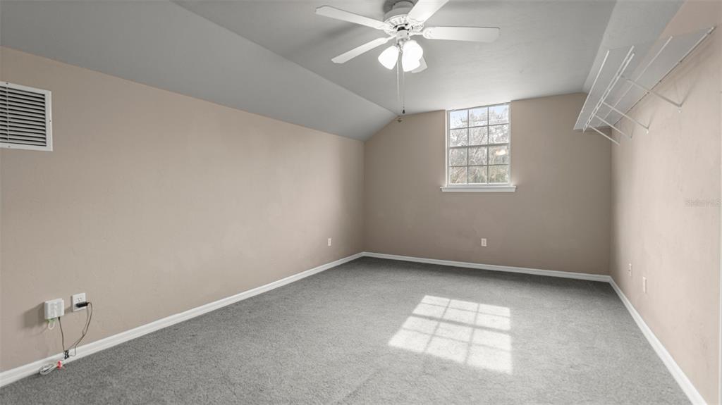 9428 Southwest 39 Avenue Gainesville, FL 32608 - Photo 18 of 43 an empty room with a window and a fan