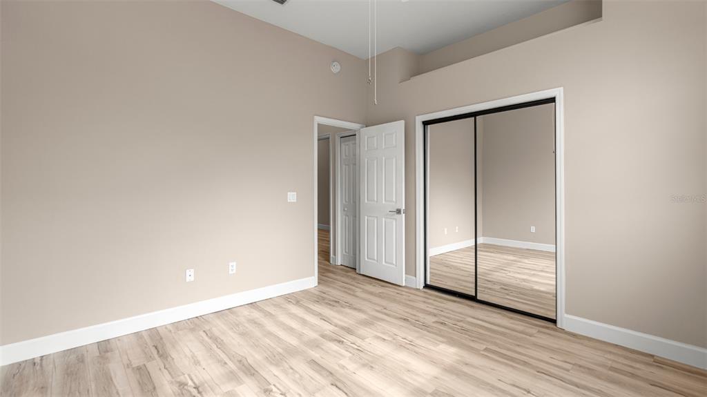 9428 Southwest 39 Avenue Gainesville, FL 32608 - Photo 22 of 43 a view of an empty room with wooden floor and closet