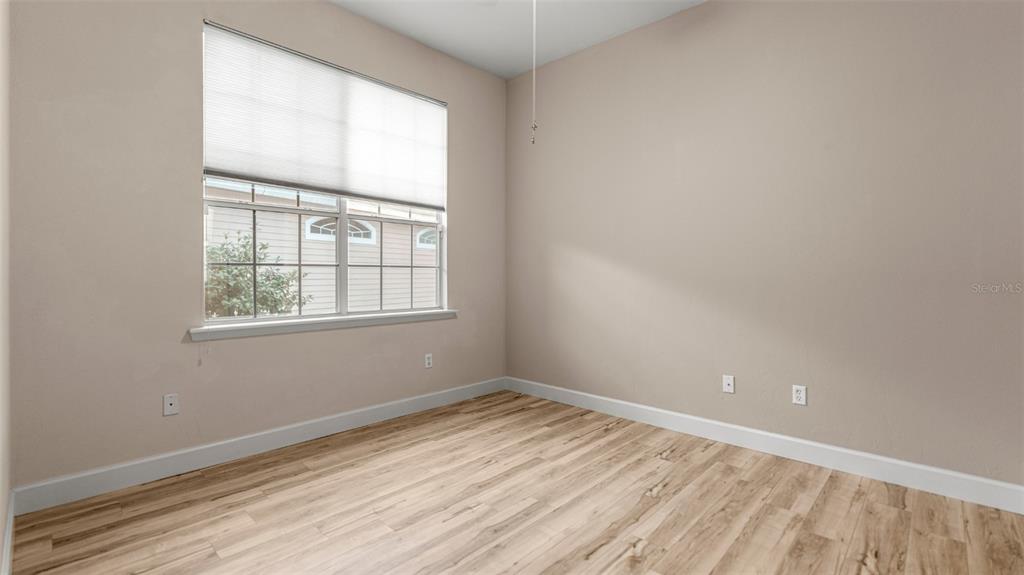 9428 Southwest 39 Avenue Gainesville, FL 32608 - Photo 23 of 43 an empty room with wooden floor and windows