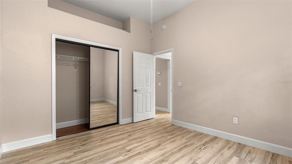 9428 Southwest 39 Avenue Gainesville, FL 32608 - Photo 24 of 43 a view of an empty room with wooden floor and closet
