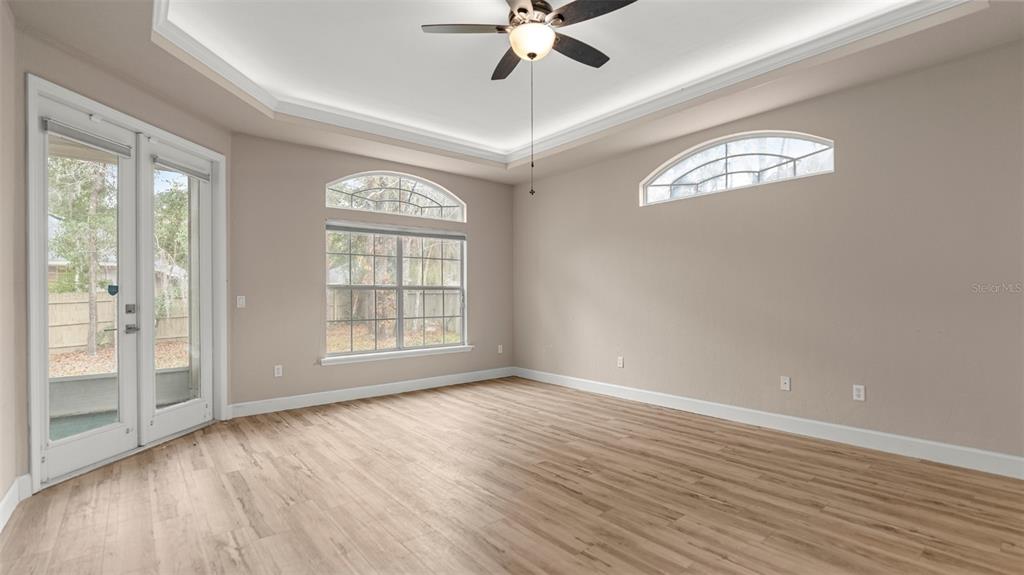 9428 Southwest 39 Avenue Gainesville, FL 32608 - Photo 25 of 43 a view of an empty room with wooden floor and a window