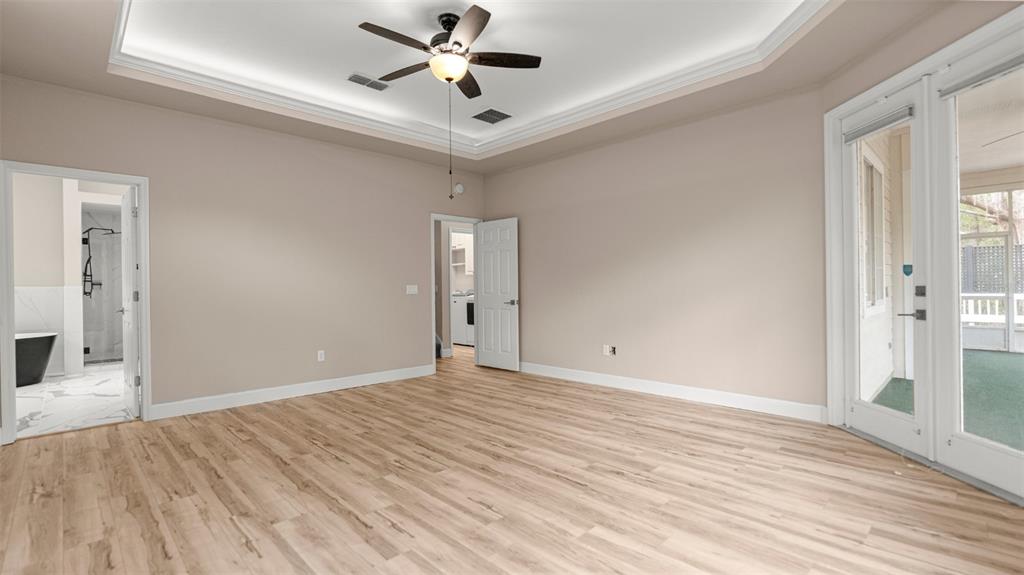9428 Southwest 39 Avenue Gainesville, FL 32608 - Photo 26 of 43 a view of an empty room with wooden floor and a window