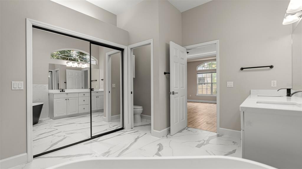 9428 Southwest 39 Avenue Gainesville, FL 32608 - Photo 31 of 43 a spacious bathroom with a shower sink and mirror
