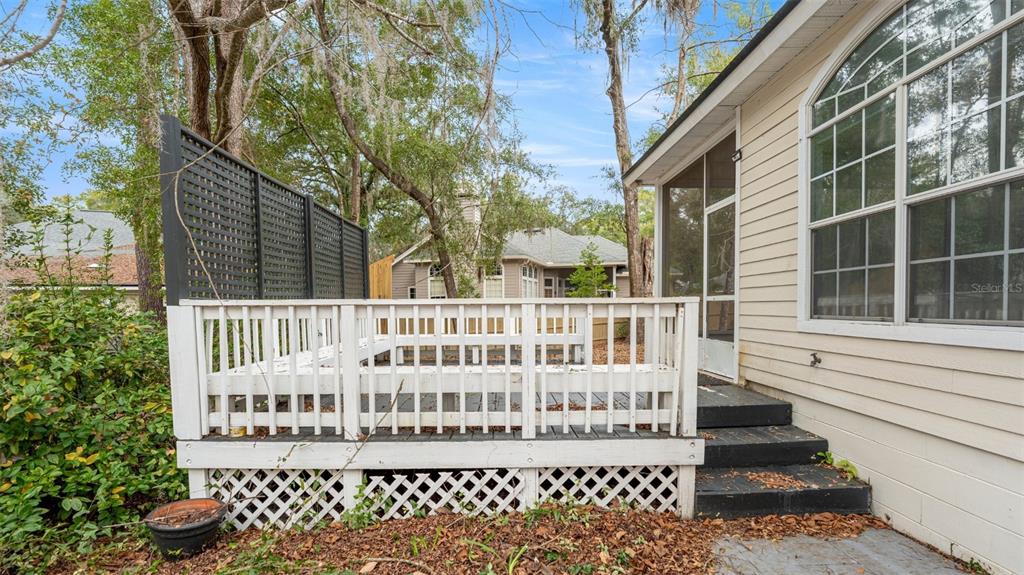 9428 Southwest 39 Avenue Gainesville, FL 32608 - Photo 36 of 43 a view of a brick house with a deck and furniture
