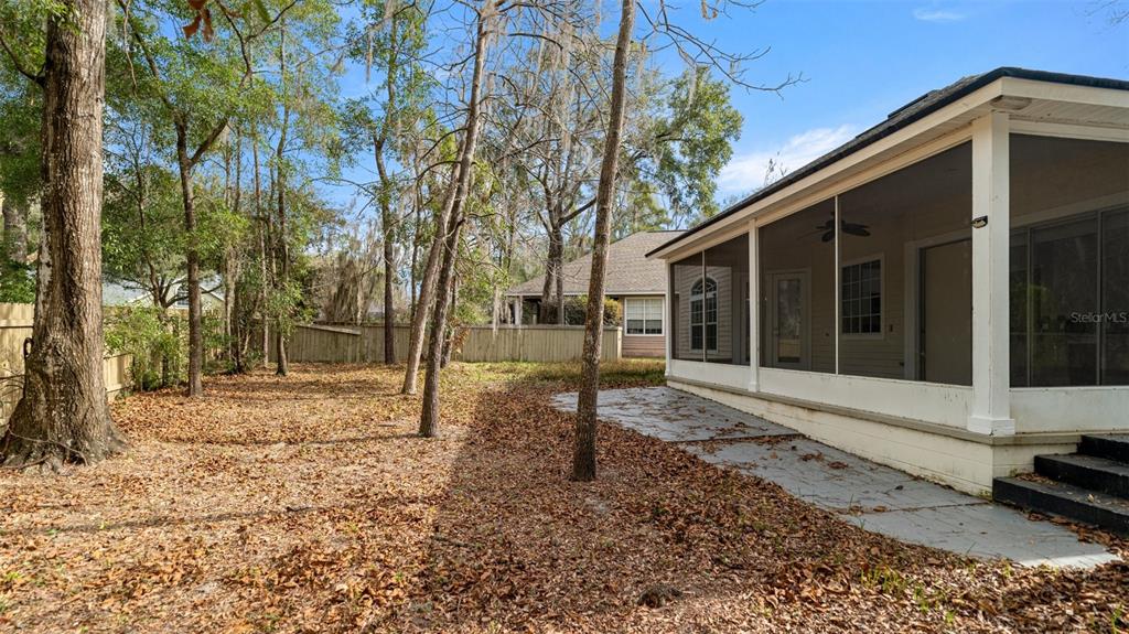 9428 Southwest 39 Avenue Gainesville, FL 32608 - Photo 39 of 43 a backyard of a house with lots of green space