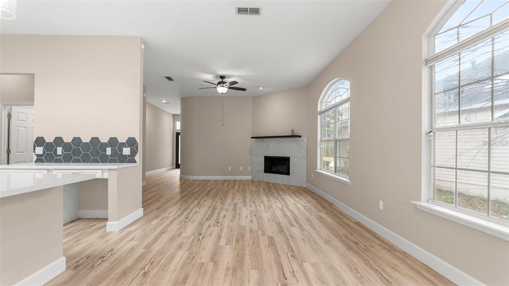 9428 Southwest 39 Avenue Gainesville, FL 32608 - Photo 7 of 43 a view of empty room with wooden floor and fireplace