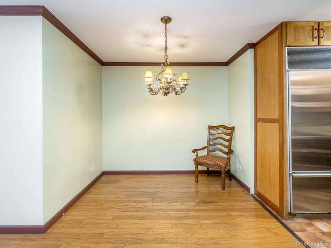 225 East 57th Street, Unit 1L Manhattan, NY 10022 - Photo 12 of 20 a view of a room with window and chandelier