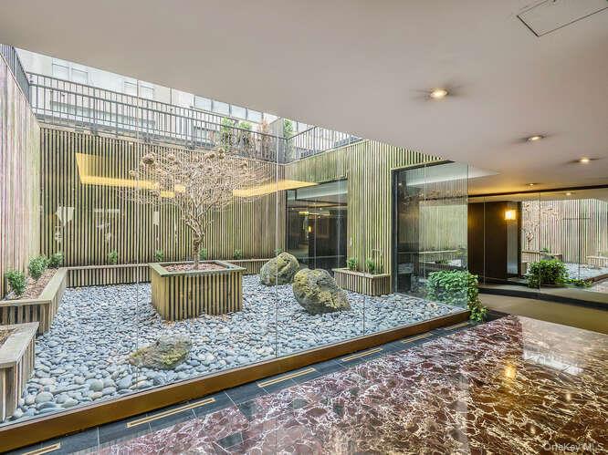 225 East 57th Street, Unit 1L Manhattan, NY 10022 - Photo 3 of 20 a view of a house with backyard and porch