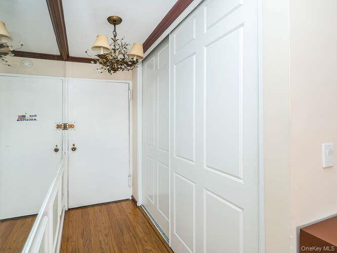 225 East 57th Street, Unit 1L Manhattan, NY 10022 - Photo 6 of 20 a very nice looking hallway with a chandelier
