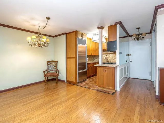 a view of a kitchen with a sink and a refrigerator