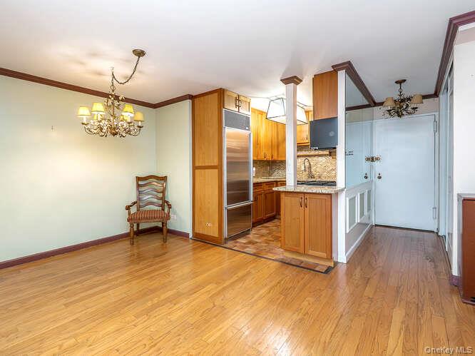225 East 57th Street, Unit 1L Manhattan, NY 10022 - Photo 7 of 20 a view of a kitchen with a sink and a refrigerator