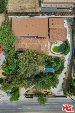 an aerial view of a house with a yard