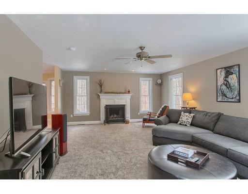 85 Chicopee Row Groton, MA 01450 - Photo 11 of 30 a living room with furniture a fireplace and a flat screen tv