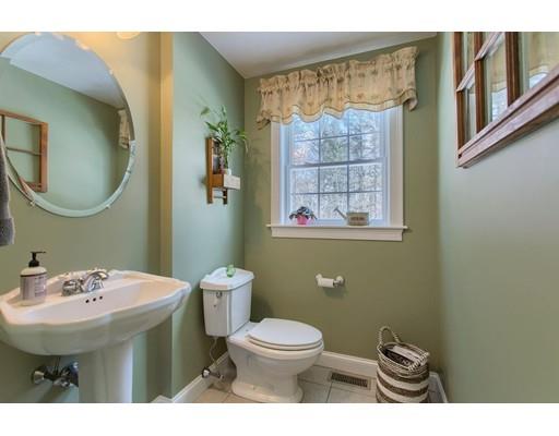 85 Chicopee Row Groton, MA 01450 - Photo 13 of 30 a bathroom with a toilet a sink and mirror