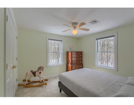 85 Chicopee Row Groton, MA 01450 - Photo 18 of 30 a bedroom with a bed and a chandelier