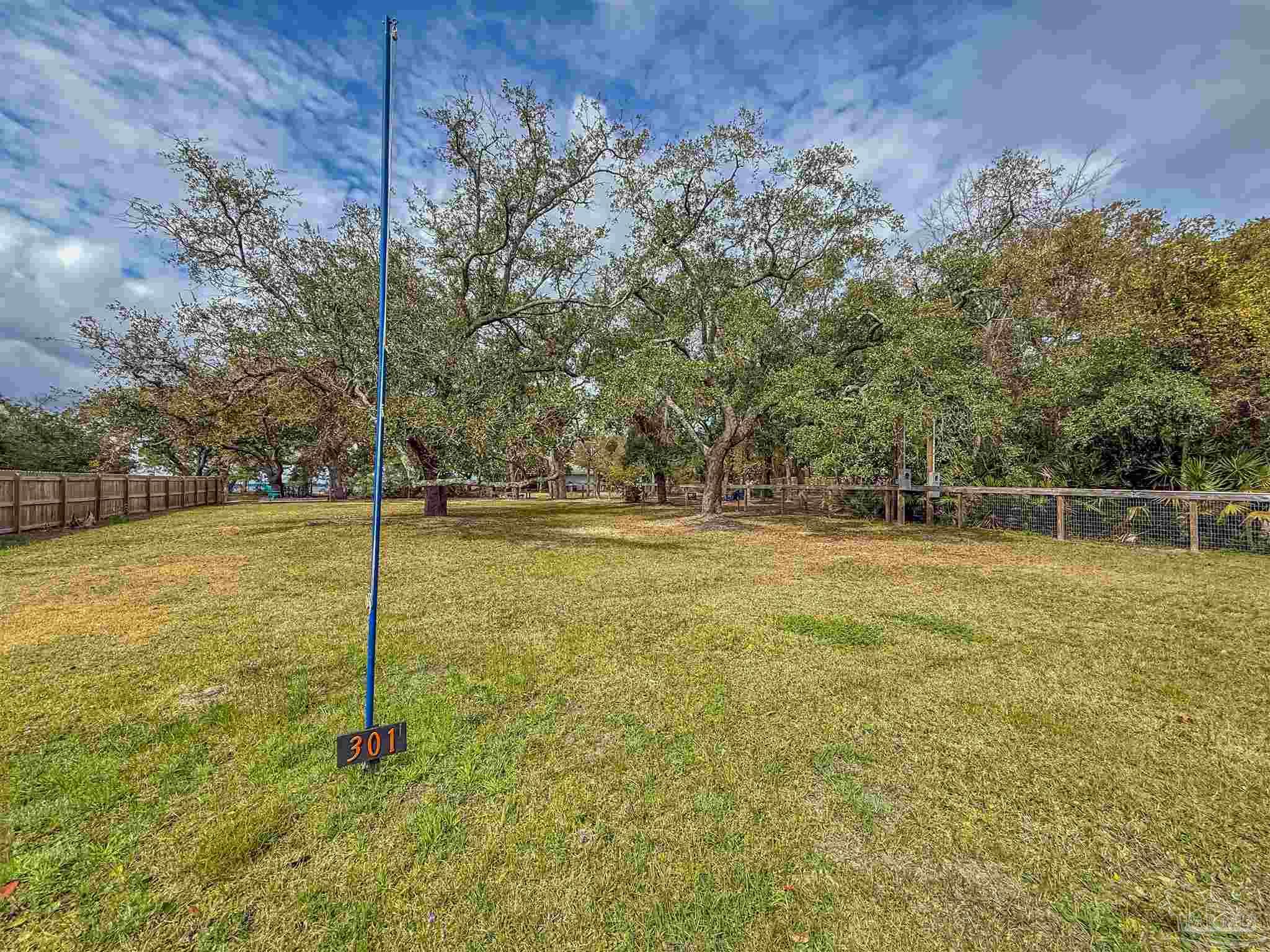 301 Katie Street Milton, FL 32583 - Photo 14 of 16 a backyard of a house with lots of green space